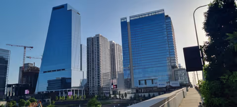 The downtown Nashville skyline in summer sunshine, with the Pinnacle tower and Grand Hyatt rising above the Gulch